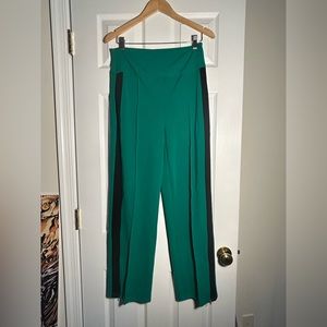 Green track pants with stripe
